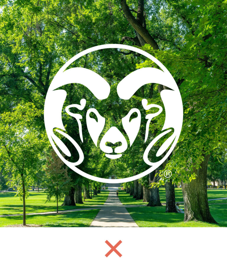 Reverse CSU Ram's Head Symbol on a photo of trees with a red X beneath
